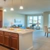 Wide angle shot of a spacious, open living room and dining area in an Erickson apartment. 