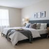 Cozy bedroom in an Erickson Senior Living community apartment with modern furnishings.