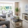 Wide angle shot of a spacious, open living room and dining area in an Erickson apartment. 