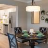 Modern kitchen in an Erickson Senior Living community apartment with updated appliances and circular breakfast table with seating for four.