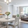 Wide angle shot of a spacious, open living room and dining area in an Erickson apartment. 