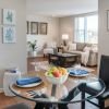 Wide angle shot of a spacious, open living room and dining area in an Erickson apartment. 