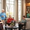 Group of older adults relaxing and reading together in a bright, cozy lounge with large windows and bookshelves, enjoying a social community setting.
