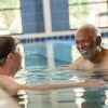 2 residents talking in the pool