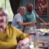 Residents socializing at a community bar area, enjoying drinks and conversation in a warm and relaxed setting.