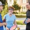 Three Residents Talking on a pickleball court