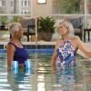Two residents chatting in the indoor pool